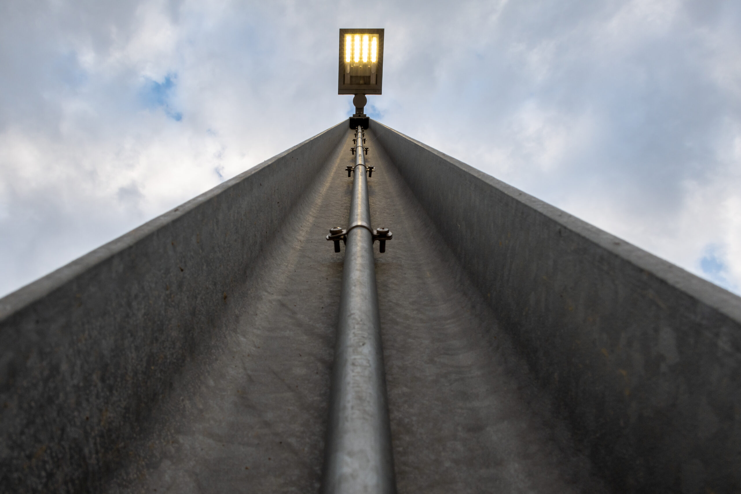 Lampadaire extérieur éclairant un accès de logement avant l’automne